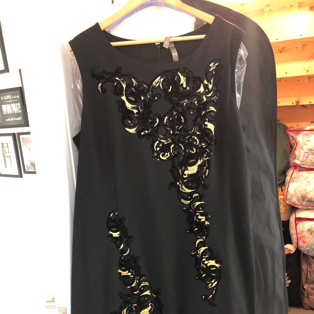 Black dress with gold flower inlays.